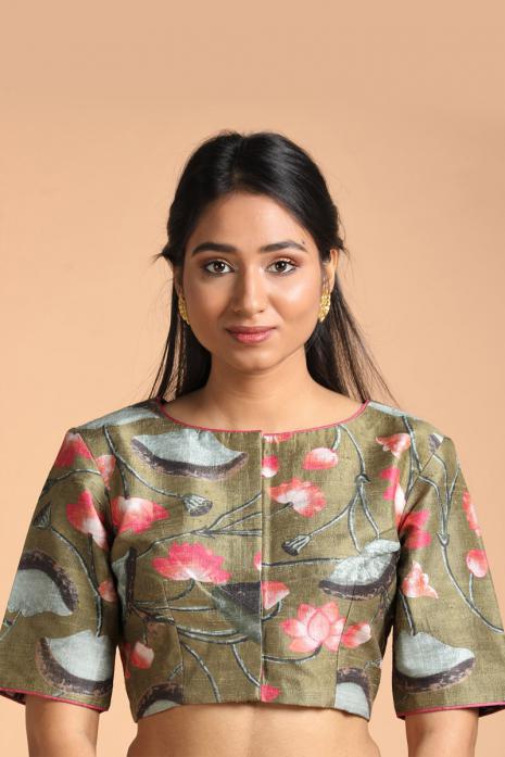 Green coloured Pichwai printed blouse crafted from luxurious raw silk fabric.