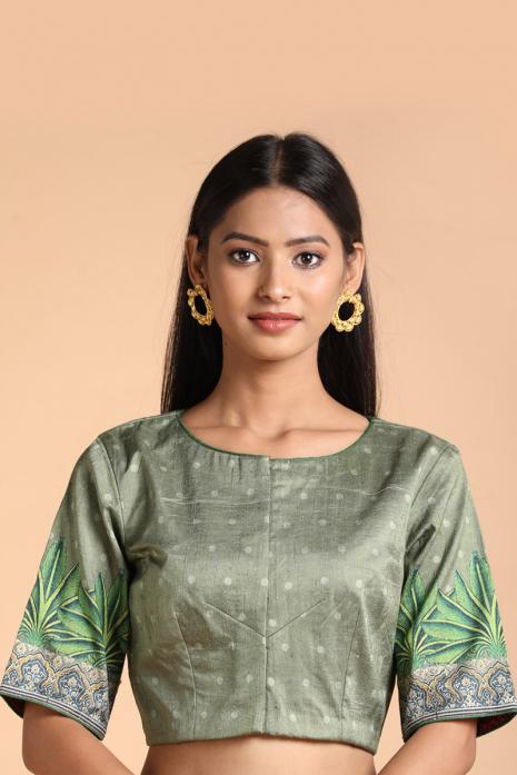 Green coloured Pichwai printed blouse crafted from luxurious raw silk fabric.