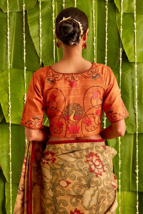 Orange coloured Pichwai handpainted blouse crafted from luxurious ghicha silk fabric.