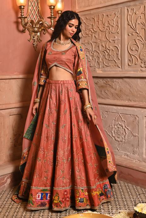 A beautiful hand-painted and hand-embroidered lehenga set in peach colour